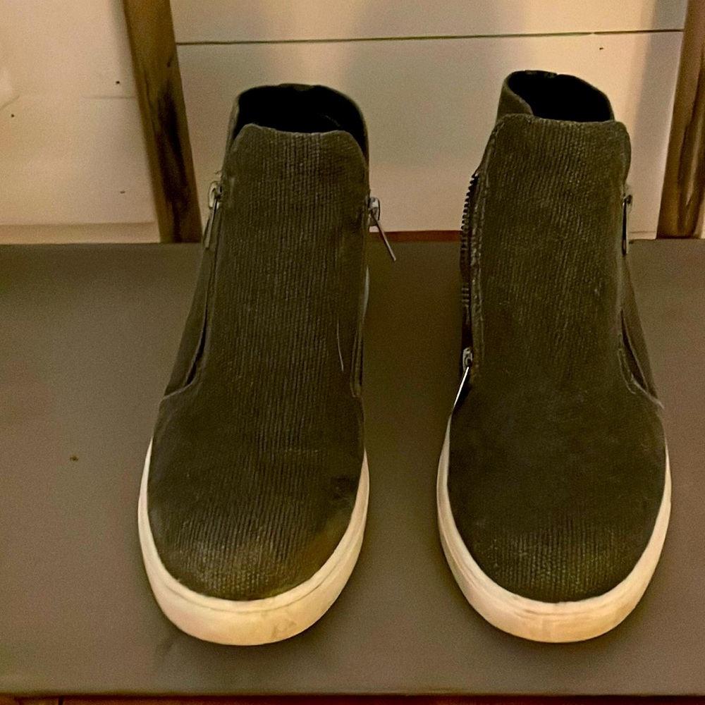 Distressed gray women’s wedge sneaker boots.